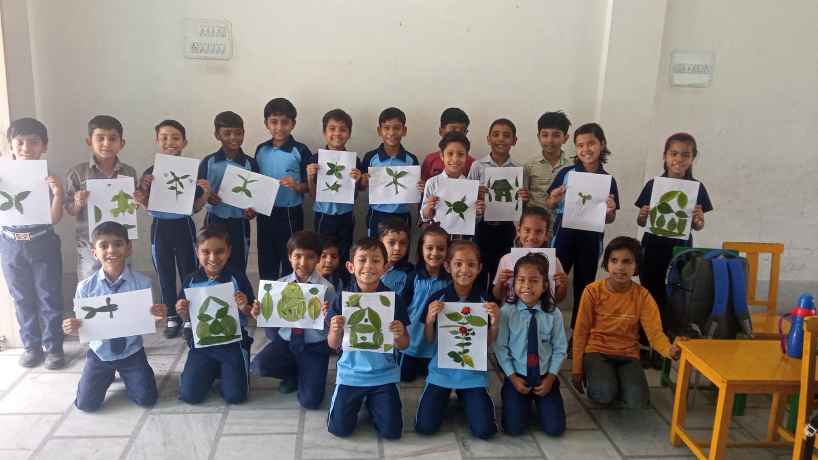Students displaying their leaf artwork